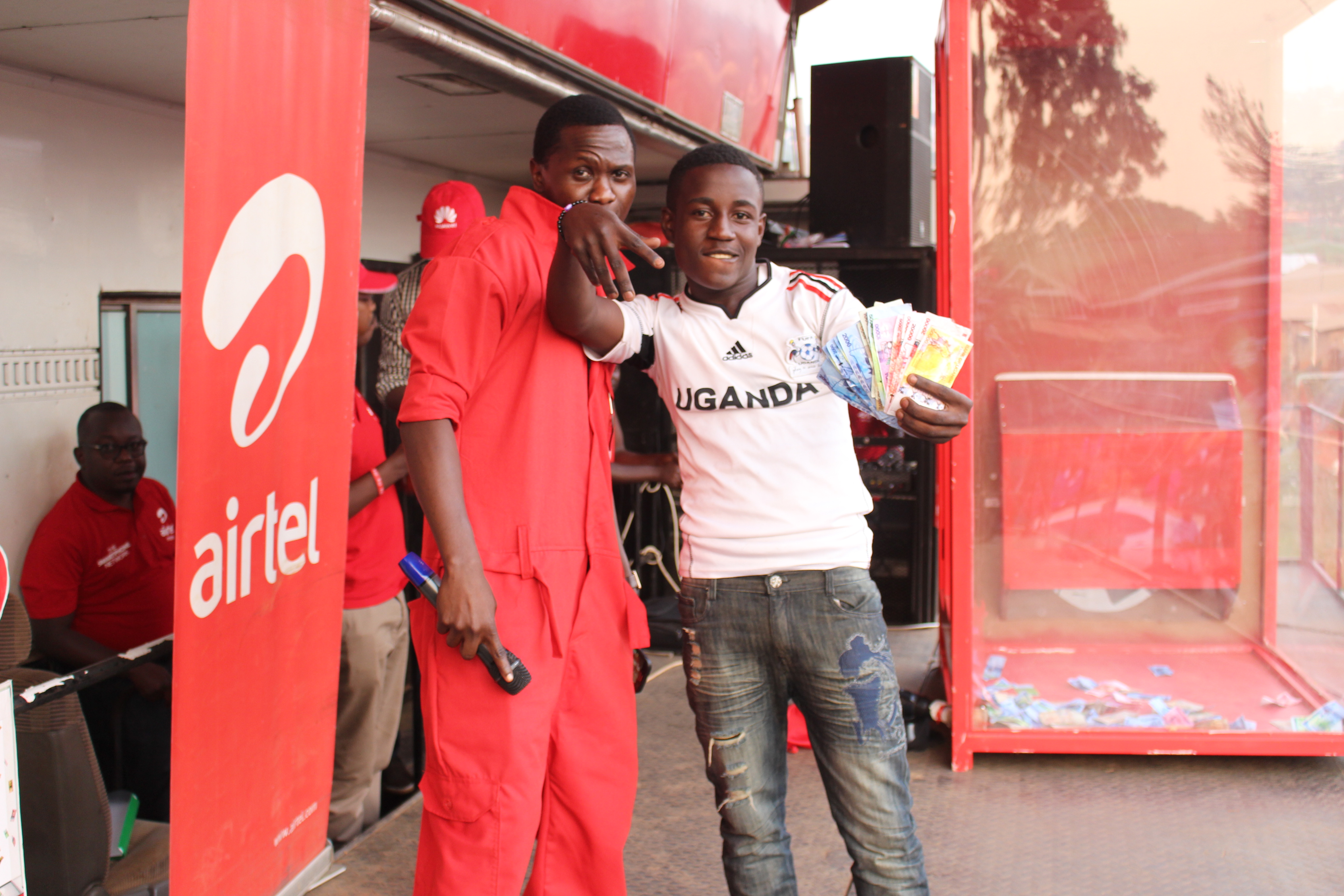 One of the lucky winners of the Yoola Amajja with Airtel Money poses for...