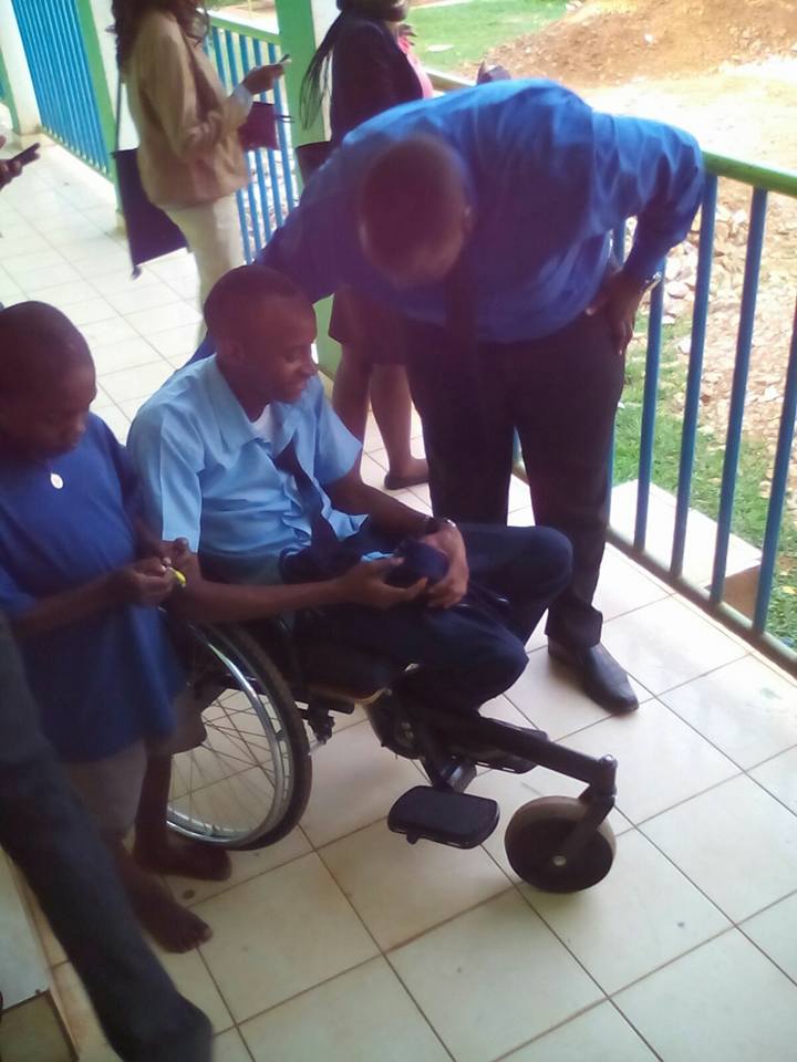 Matovu Jorum having a word with a disabled man.