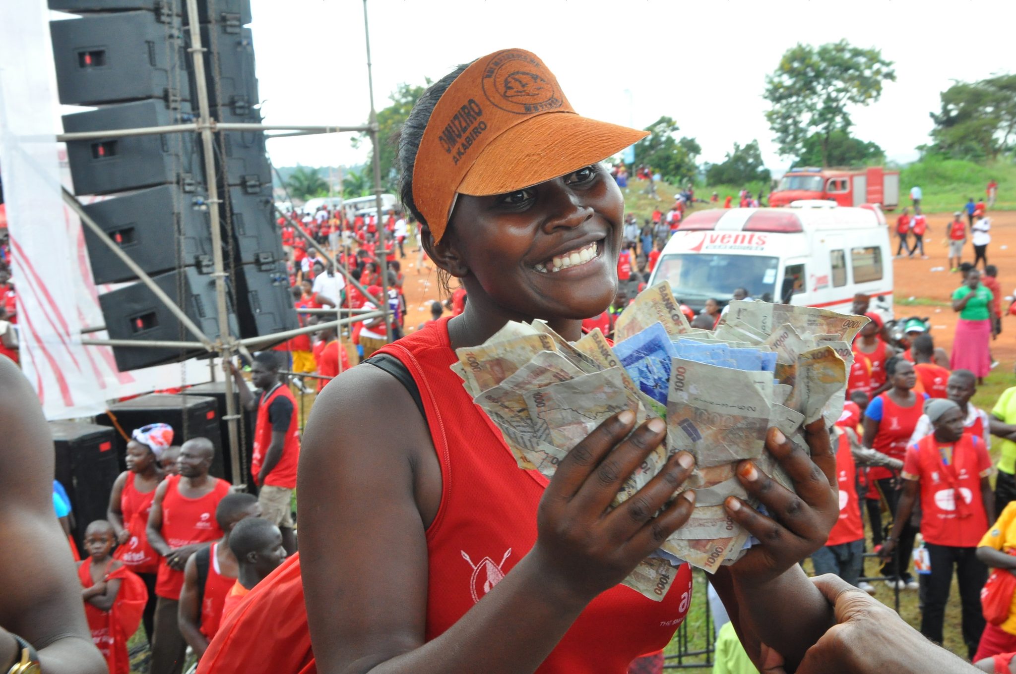 Farida Nasegge displays the money she won during the Yoola Amajja activation at the Kabaka Birthday Run.
