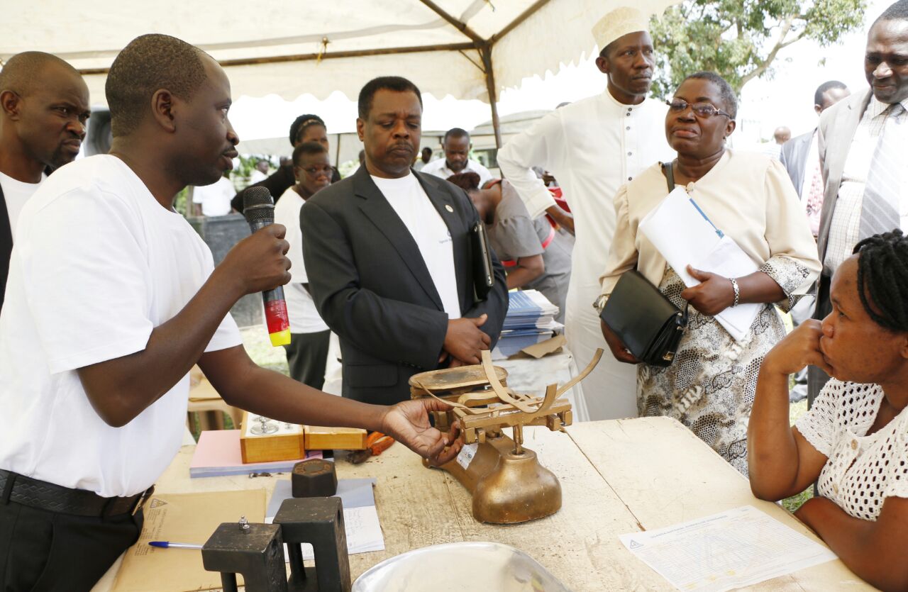 A UNBS official demostrates to how a verified counter  weighing scale works at the World Metrology Day held in Mukono last  week
