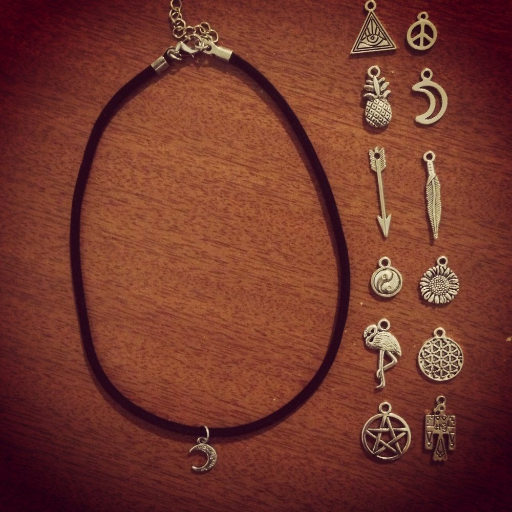 A thin charm choker with various charms