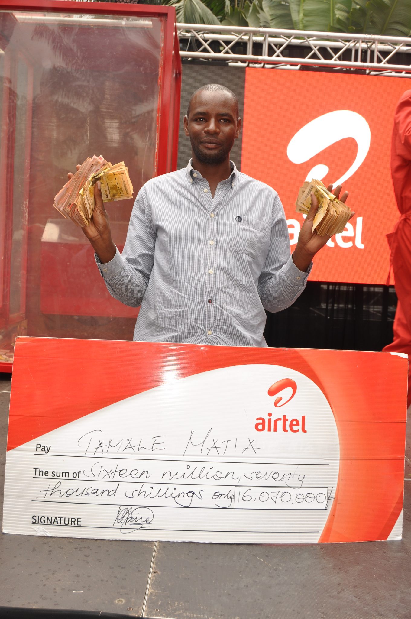 Matia Tamale a coaster driver, displays his 16m he won at the Yoola Amajja with Airtel Money grand finale.