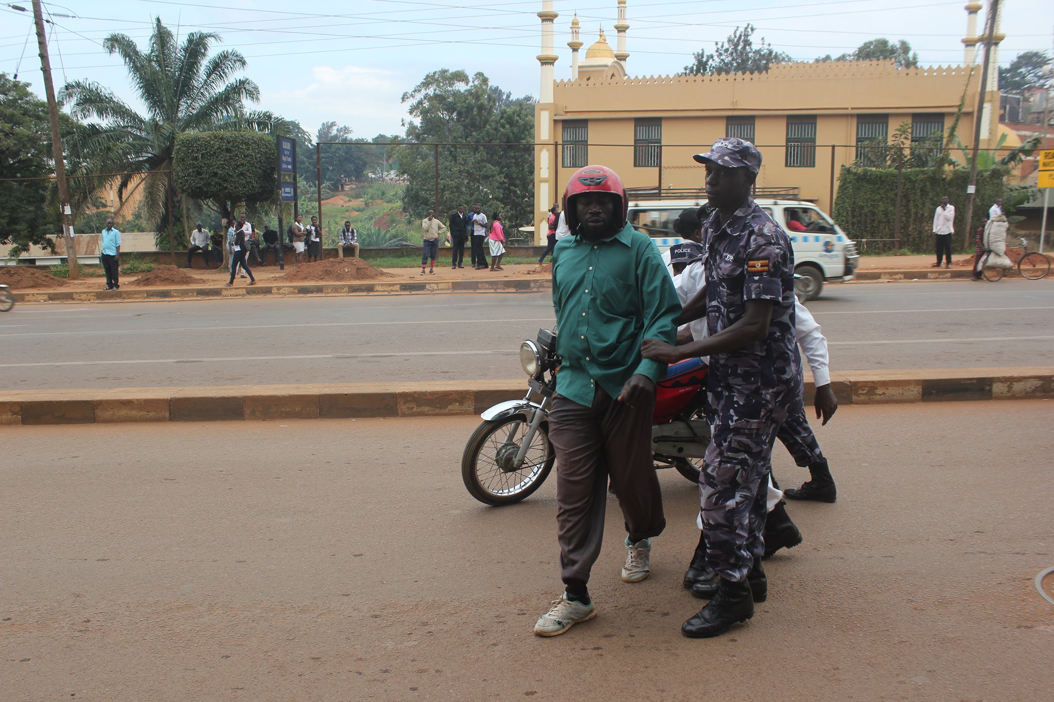 A boda guy and his boda being taken away after police found him without papers 