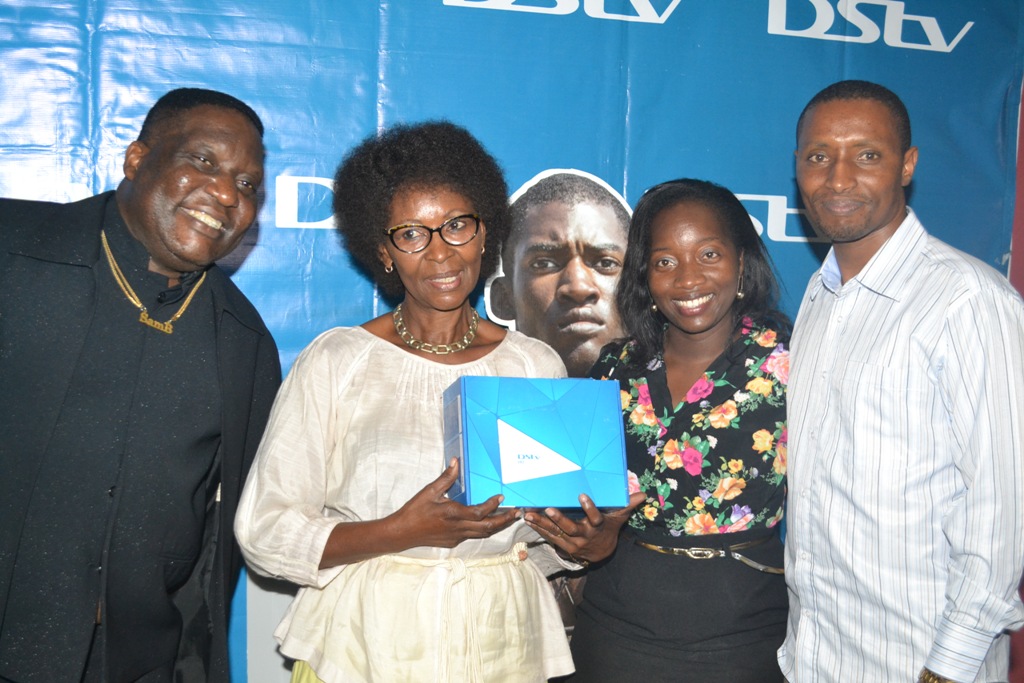 Tina Wamala (3rd Right) PR Manager MultiChoice Uganda poses with Sam Bagenda, Sarah Kisauzi and her manager after winning best dressed person at the MultiChoice Roots screening.