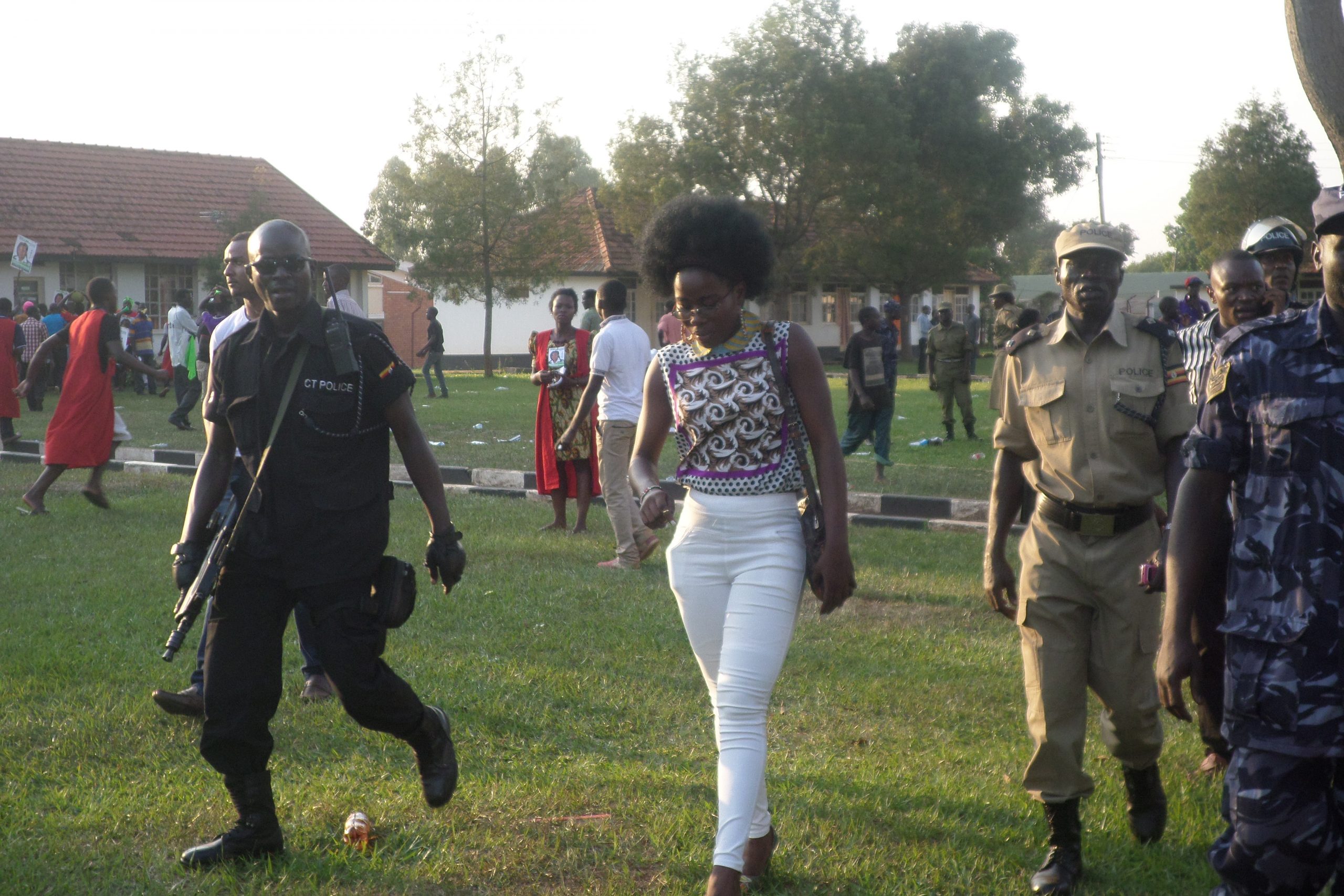 Aseru Sarah, Vice Chairperson Electoral Commission being whisked away by the Police after the rally turned violent