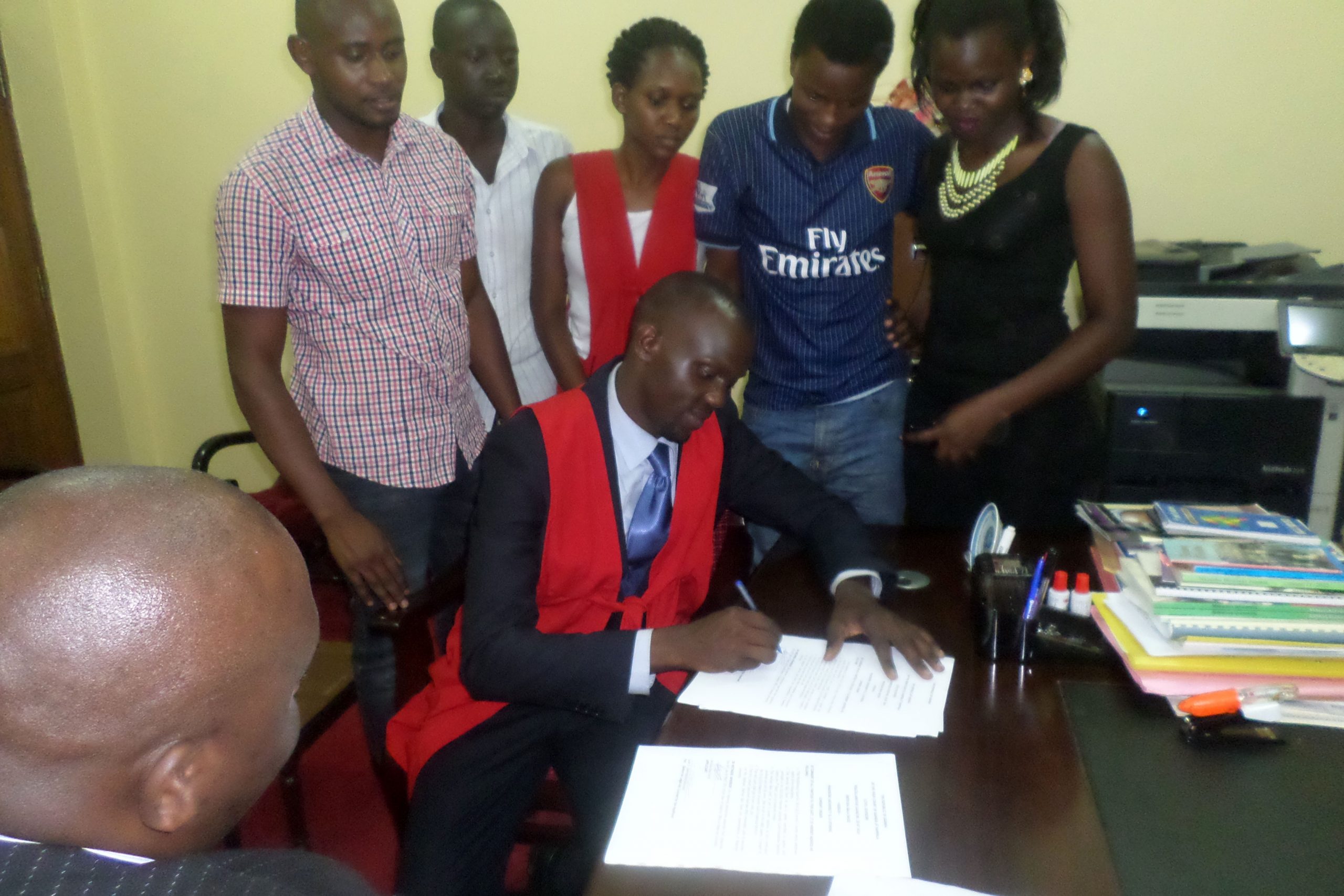 Bala David signs the consent form