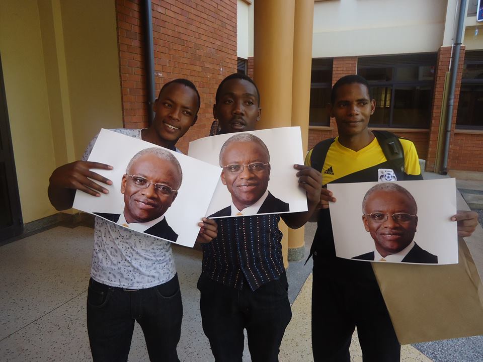 Makerere students carrying Amama Mbabazi's portrait photos.