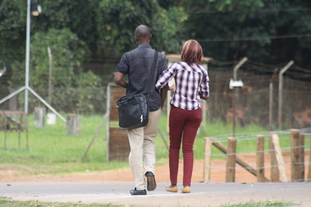A couple takes a stroll through the 'streets' of Makerere University after lectures.