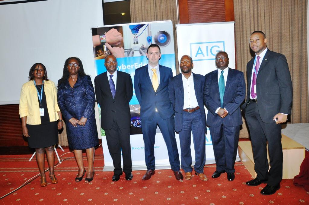 Officials from AIG led by the MD Ms. Ann Othieno pose for a photo with the MD of Stanchart Mr. Herman Kasekende. This was during the press conference to launch the new AIG CyberEdge Insurance policy