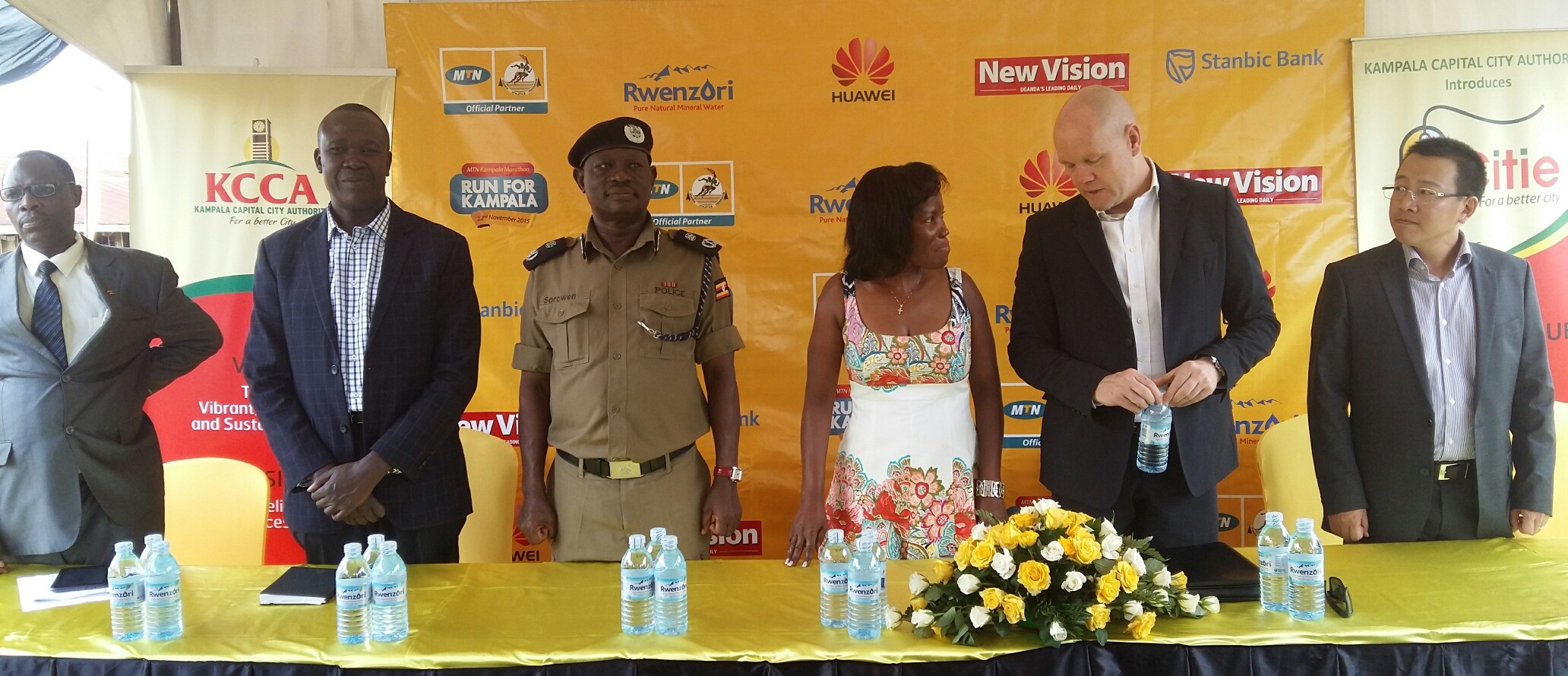 MTN CEO Brian Gouldie shakes hands with the KCCA ED Jennifer Musisi after the launch of MTN Kampala Marathon 2015 edition. This was at Nsambya Police Primary school on 27th October 2015. Other officials looking on include Marathon partner representatives from Huawei, Stanbic Bank, Rwenzori Mineral water, Uganda athletic Federation and MTN officials.
