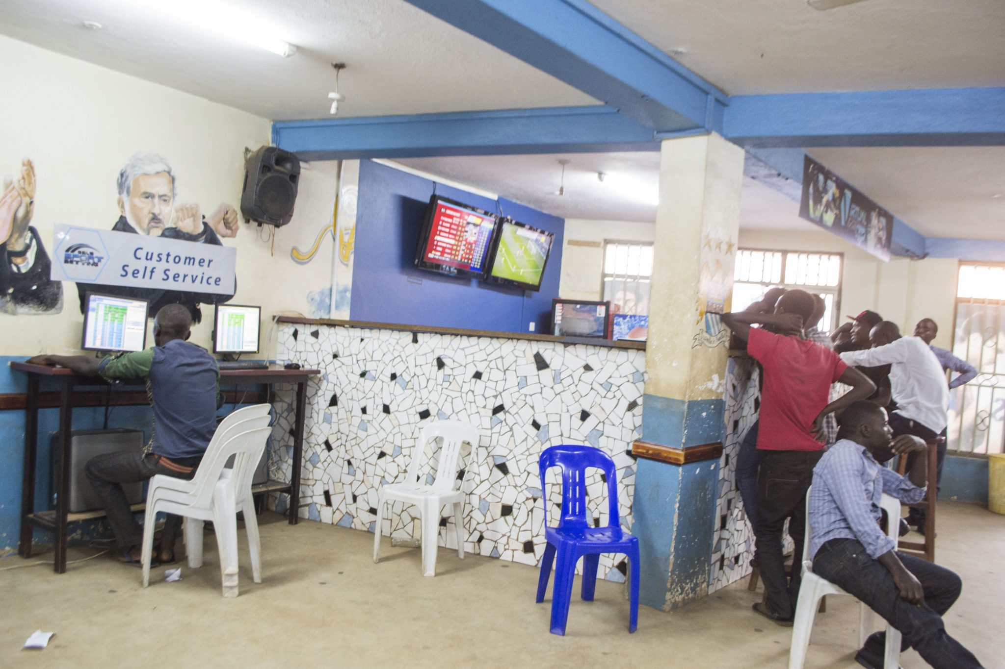 Clients follow proceedings on screens inside a Gal's Sports Betting outlet in Kampala.