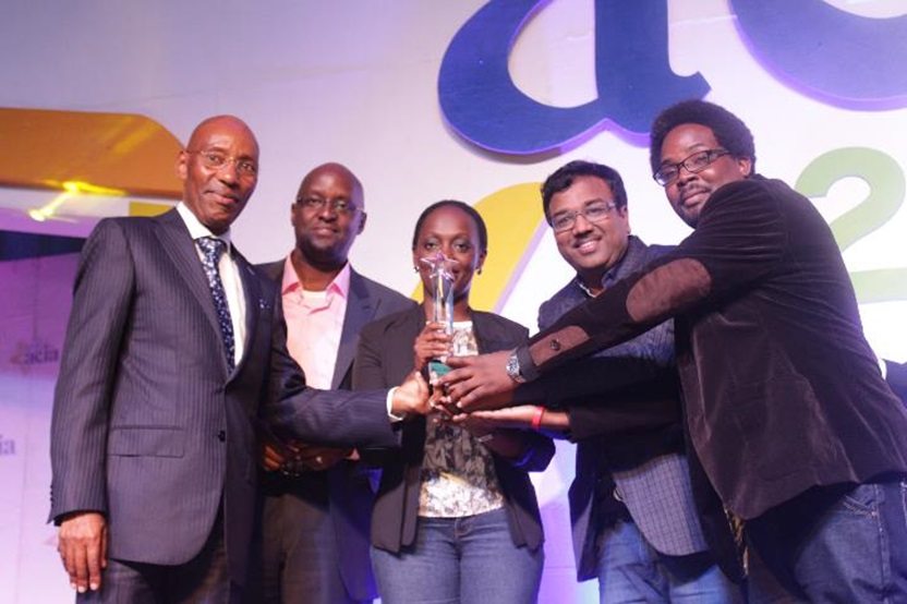 Airtel Uganda team led by Legal and Regulatory Director Dennis Kakonge receive an award from UCC Executive Director Godfrey Mutabazi at the 2016 ACIA awards.