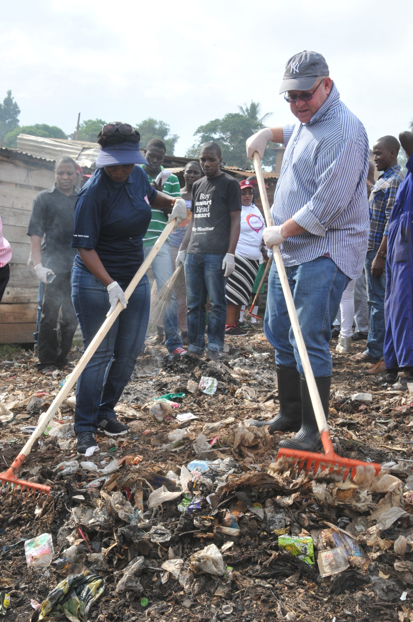 NTV's Managing Director, Aggie Asiimwe Konde and Monitor Publications Limited Managing Director, Tony Glencross participate in the community cleaning initiative.