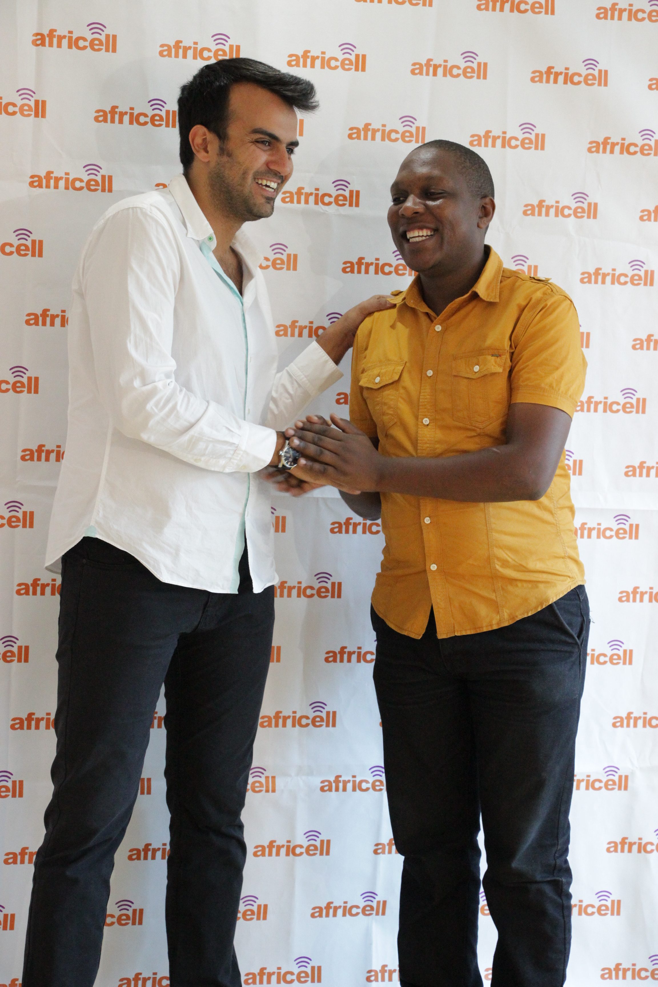 Africell Commercial Director Milad Khairallah (in white shirt) congratulates one of the first recipients of the triple MBs campaign