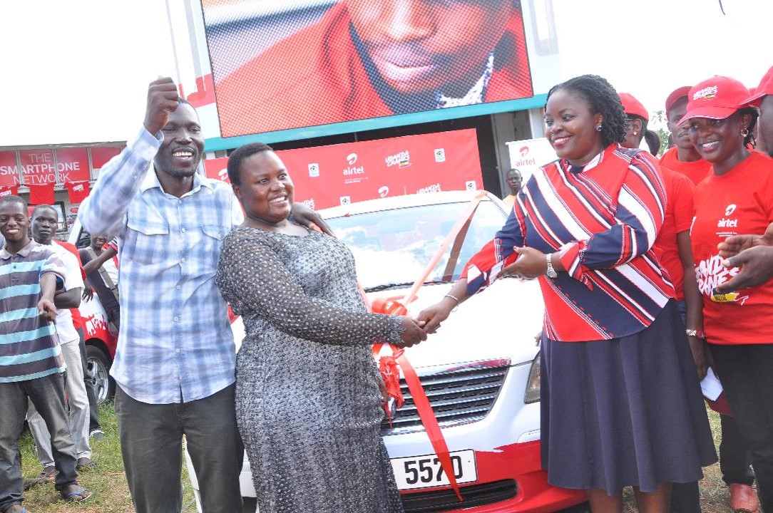 Rita Nabuzale being congratulated by Airtel's Remmie Kisakye,Head  of Brand and Communications  on her win of a brand new car.