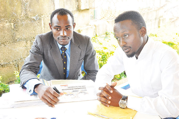 Yasin Sentumbwe Munagomba (L) and Simon Semuwemba addressing press