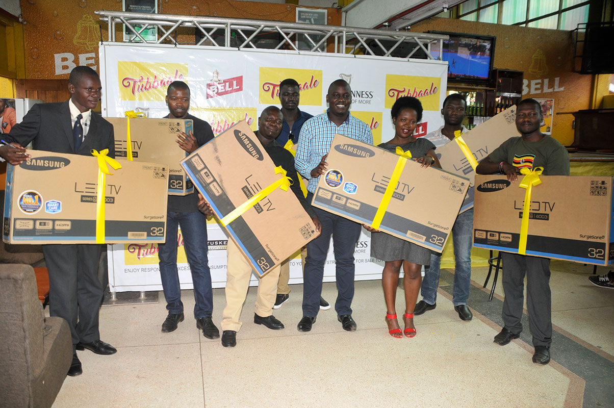 Winners of flat screen TVs show off their prizes