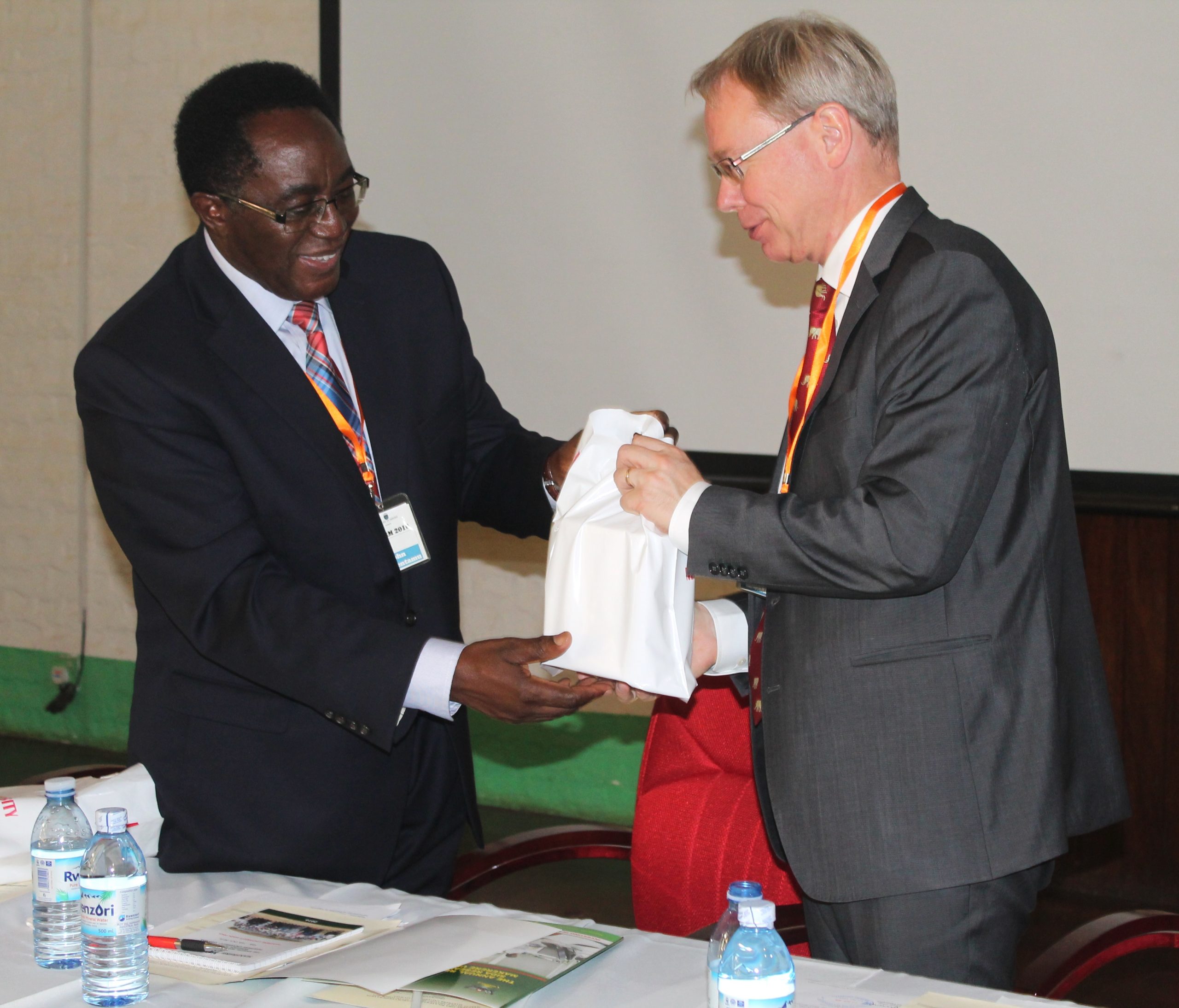 New Swedish ambassador in Uganda, Per Lindgarde,  being given a gift by Makerere University Vice Chancellor Prof John Ddumba-Ssentamu