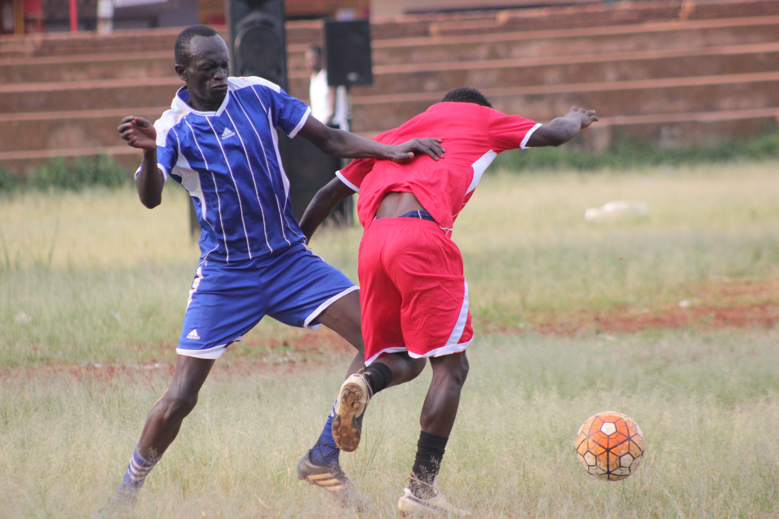 JEEMA youth player in blue taking on UPC player during finals