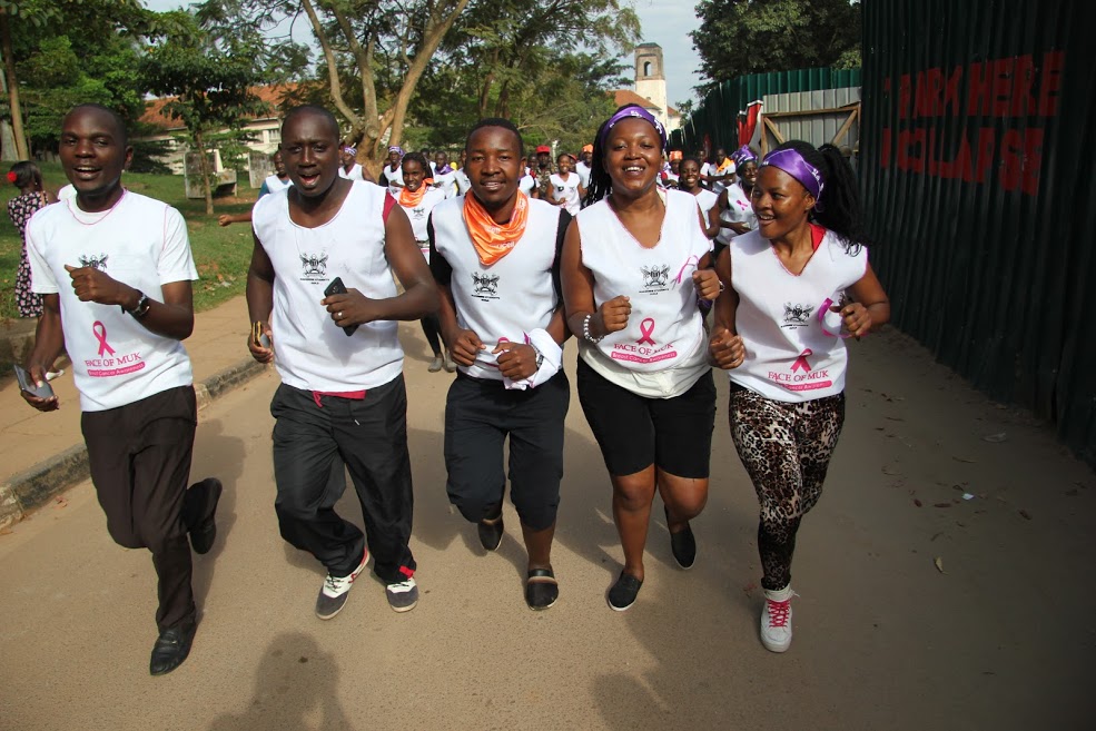 Head of security at Makerere University, Jackson Mucunguzi (L) and other participants during the run 