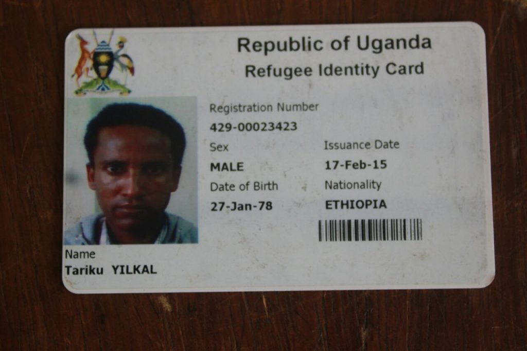 Yikal's ID identicating he is a refugee in Uganda.