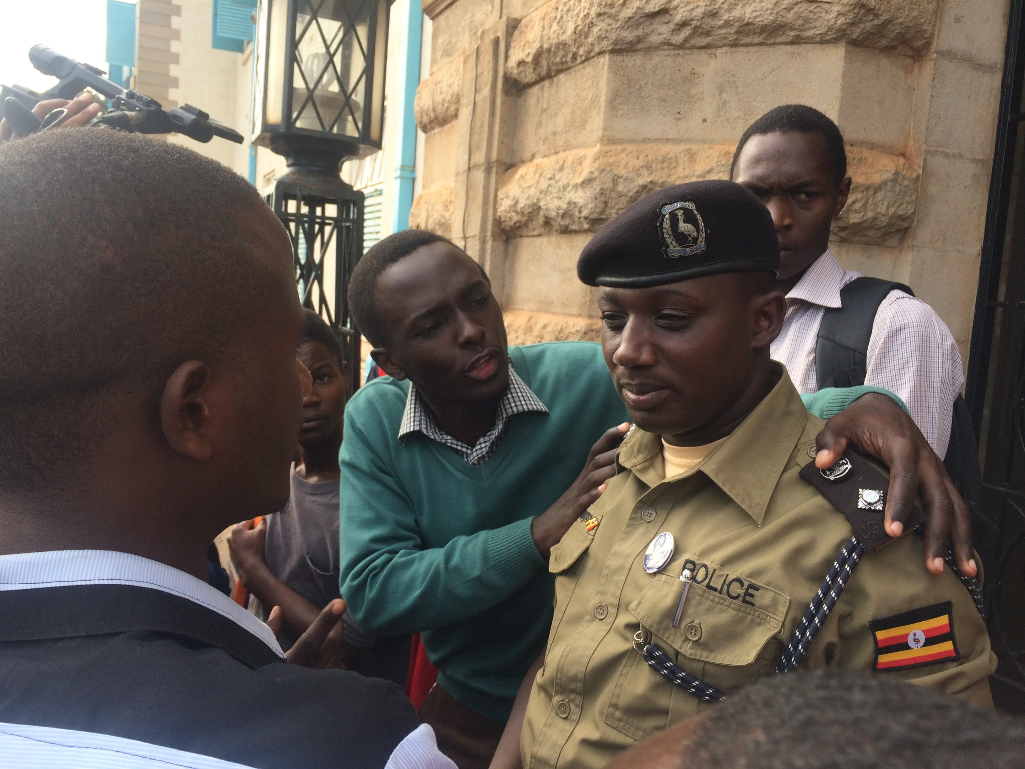 As student chats with Jeff Mucunguzi, the Makerere university head of security