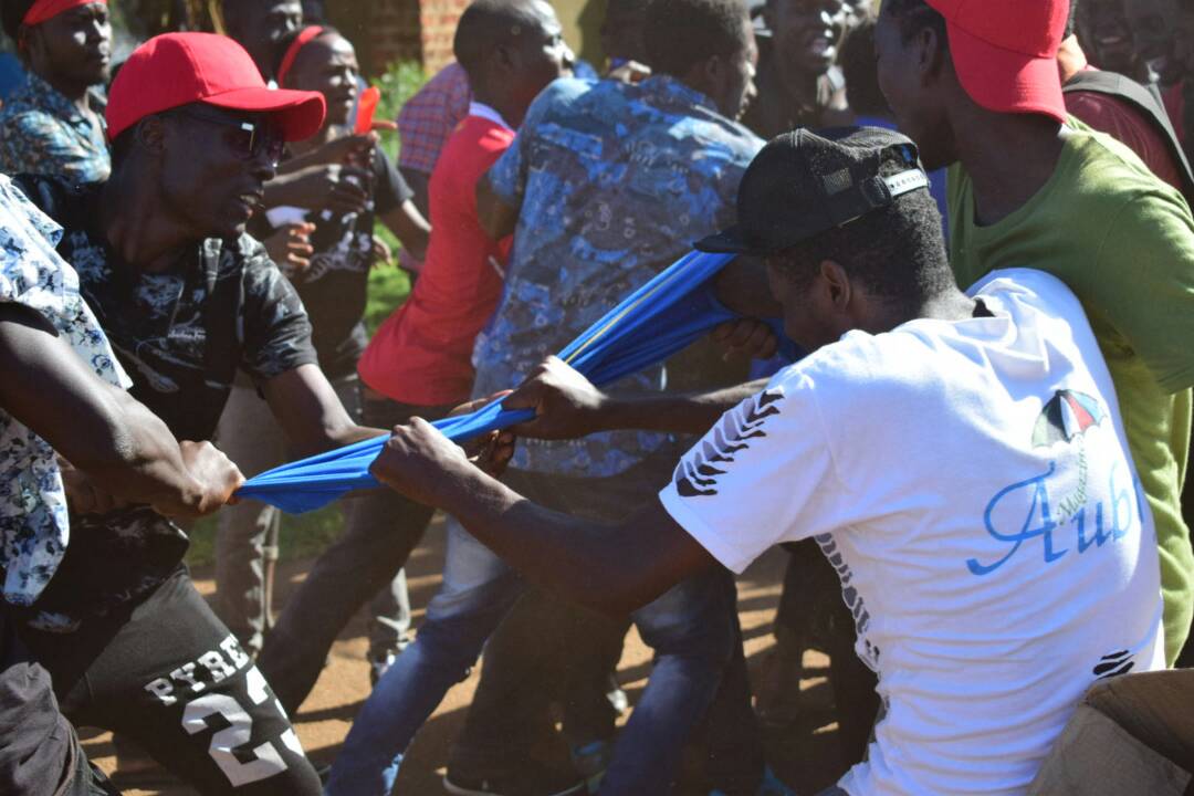 Fans fight for a Kyambogo University gown. The Nkumba fans wanted to burn it.