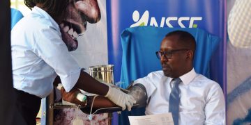 PHOTO CAPTION: NSSF Managing Director, Richard Byarugaba donates blood during the 2018 edition of the NSSF Blood Drive- the fund's social initiative that has raised 21,425 since 2012. This year, the fund aims to raise at least 15,000 units so as to end the cyclic blood shortage in the December-January period.