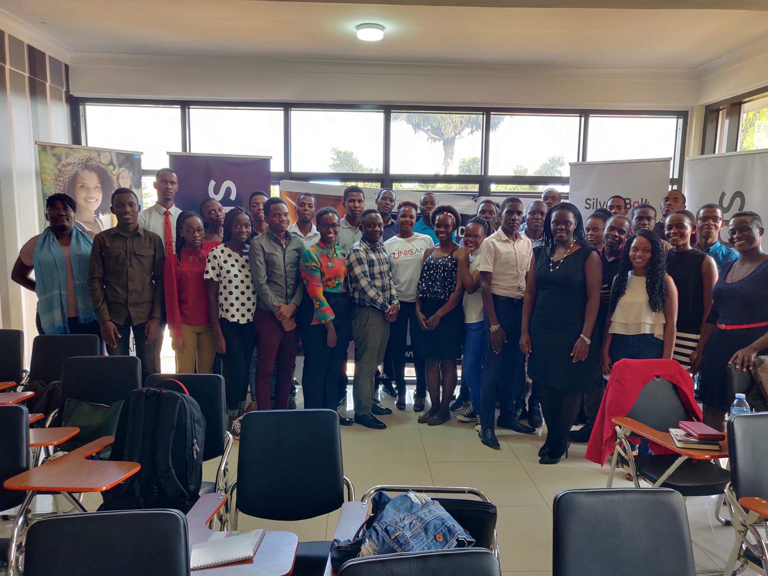 University science, engineering and technology students together with representatives from Unicaf and Silver Bullet take a photo at the launch of the 2020 Student Development Program in Kampala