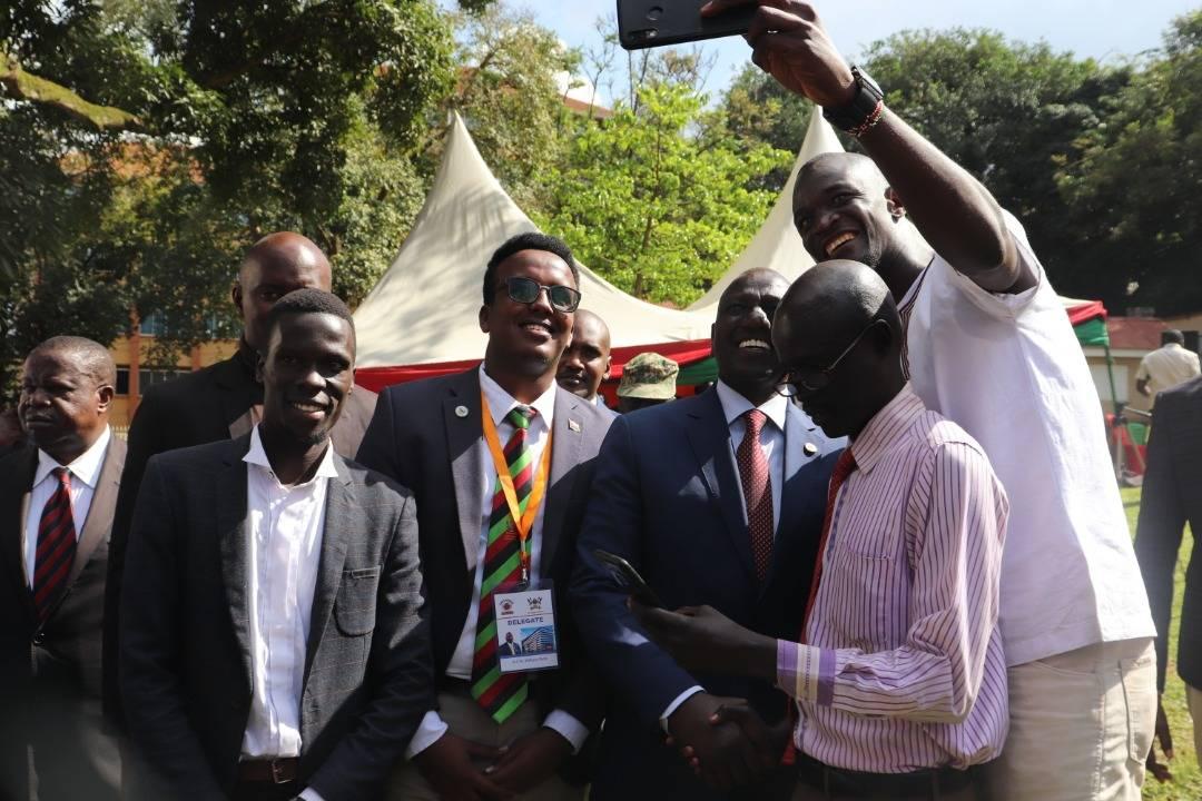 The writer (Centre) with a neck tag next to Kenya's Deputy President Ruto.