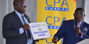 The president of the institute Constant Mayende (L) and the chief guest,  Twaha Kigongo Kaawaase flagging off the #ICPAUScholarship2022 programme