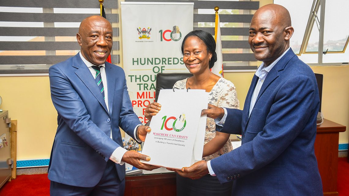 Acting Vice Chancellor, Prof. Henry Alinaitwe (Left) receive UGX 25 million cash from Dr. Robinah Kulabako and Dr. Twine Bananuka on 12th December 2022.