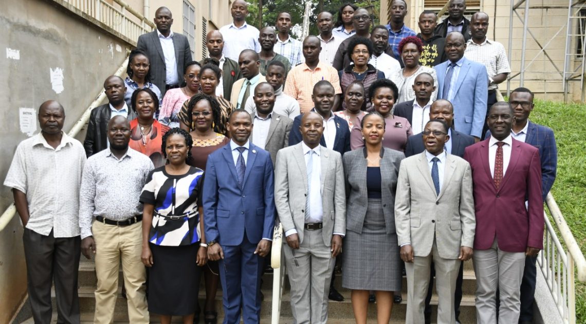 DVC Prof Umar Kakumba shares a light moment with the research fellows
