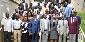 DVC Prof Umar Kakumba shares a light moment with the research fellows