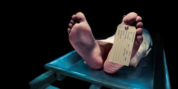 Photo of feet with toe tag on a mortuary table | Courtesy